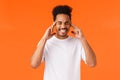 Distressed and tensed african-american male in white t-shirt, clench teeth, close eyes and touch temples, feeling