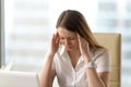 Distressed unhappy businesswoman suffering from headache, massag