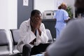 Distressed unhappy doctor sitting in clinic