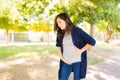 Distressed woman having contractions outdoors