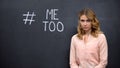 Distressed woman standing near Metoo hashtag, movement against sexual assault Royalty Free Stock Photo