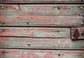 Distressed Wood. Wooden Door with Handle and Remains of Mint and Grey Paint. Dark Wooden Wall. Royalty Free Stock Photo
