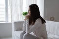 Distressed young female sitting on couch meeting morning with tears Royalty Free Stock Photo