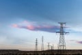 Distribution of electric towers at dusk Royalty Free Stock Photo