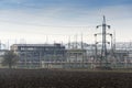 Distribution power station with electricity pylons and dramatic cloudy sky Royalty Free Stock Photo