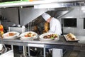 The distribution table in the kitchen of the restaurant. the chef prepares a meal on the background of the finished Royalty Free Stock Photo