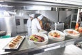 The distribution table in the kitchen of the restaurant. the chef prepares a meal on the background of the finished Royalty Free Stock Photo