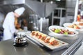 The distribution table in the kitchen of the restaurant. the chef prepares a meal on the background of the finished Royalty Free Stock Photo