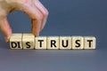 Distrust or trust symbol. Businessman turns wooden cubes, changes words `distrust` to `trust`. Beautiful grey table, grey Royalty Free Stock Photo