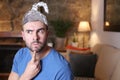 Distrustful man wearing weird tinfoil hat Royalty Free Stock Photo