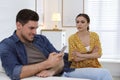 Distrustful woman peering into boyfriend`s smartphone. Jealousy in relationship Royalty Free Stock Photo