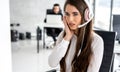 Disturbed female support operator listening carefully client while talking over headset in call center. Royalty Free Stock Photo