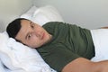 Disturbed looking man in bed Royalty Free Stock Photo