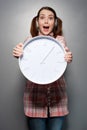 Disturbed woman holding wall clock Royalty Free Stock Photo