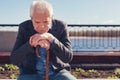 Upset senior man pondering while sitting on bench