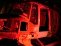 Disused abandoned Helicopter grounded at night with red night lighting to show nose body and component parts