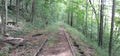 Disused railroad tracks stretch into the distance