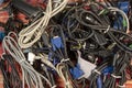 Disused stack of old computer cables and devices.