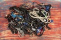 Disused stack of old computer cables and devices.