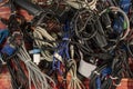 Disused stack of old computer cables and devices-