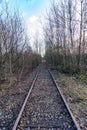 Disused straight old railway track disappearing into background Royalty Free Stock Photo