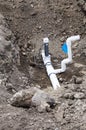 Ditch with plumbing pipe and valve Royalty Free Stock Photo