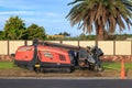 A `Ditch Witch` JT2020 horizontal directional drill beside a road