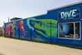 The Dive food and spirits restaurant with a beautiful wall mural with a shark, a jellyfish and a turtle and blue sky Royalty Free Stock Photo