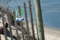 A dive mask left behind on a fence at the beach.