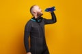 Diver drinking on bright studio wall background