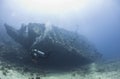 Diver exploring a large shipwreck