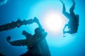 Diver silhouette near propeller ship wreck in the blue sea Royalty Free Stock Photo