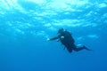 Diver swimming in deep blue water