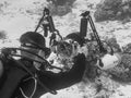 Diver taking underwater photos, grayscale shot Royalty Free Stock Photo