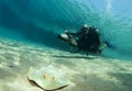 Diver on underwater scooter with sting ray Royalty Free Stock Photo