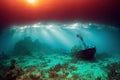 Diver underwater view of sunset and sunken ship at the bottom of the sea. Royalty Free Stock Photo