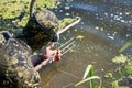 diver in wet suit loading harpoon shotgun for water hunting fishing in a river