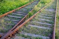 The divergence of two railway tracks that have not been used for a long time. Rusty iron rails. Wooden sleepers. The