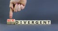 Divergent or neurodivergent symbol. Concept words Divergent Neurodivergent on wooden blocks. Beautiful grey table grey background