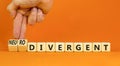 Divergent or neurodivergent symbol. Concept words Divergent Neurodivergent on wooden blocks. Beautiful orange background.