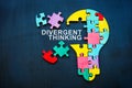 Divergent thinking sign and bulb from puzzle pieces.