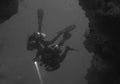 Divers entering Cathedral Cave at Pescador Island (Moalboal - Cebu - Philippines) Royalty Free Stock Photo