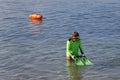 Divers during environmental cleaning beach day removing plastic