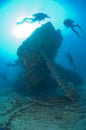 Divers exploring a large shipwreck Royalty Free Stock Photo