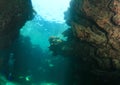 Divers swimming in undersea rift