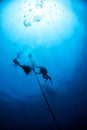 Divers under boat for deco time in the blue Royalty Free Stock Photo