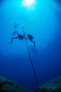 Divers under boat for deco time in the blue Royalty Free Stock Photo