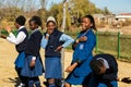 Diverse African high school pupils messing about on the sports field