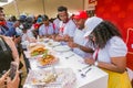 Diverse African judges tasing and scoring meals at cooking competition