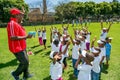 Diverse African Primary School children doing physical exercise PT lesson